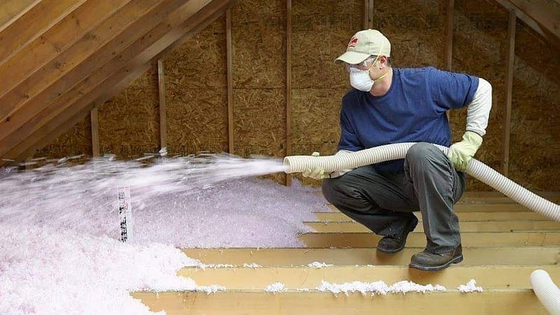 guy blowing insulation